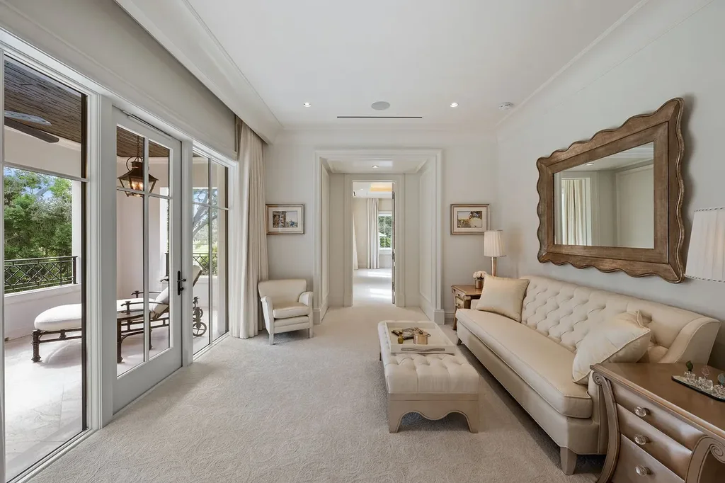 Outdoor living space with heated saltwater pool, cabana, and manicured gardens overlooking golf course