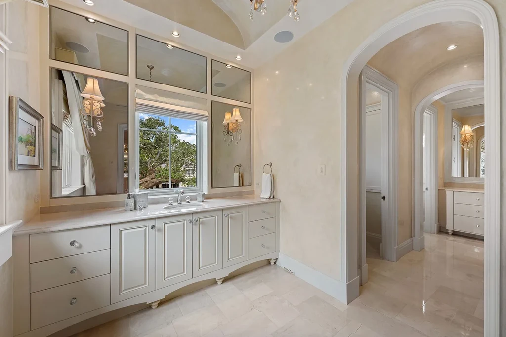 Outdoor living space with heated saltwater pool, cabana, and manicured gardens overlooking golf course